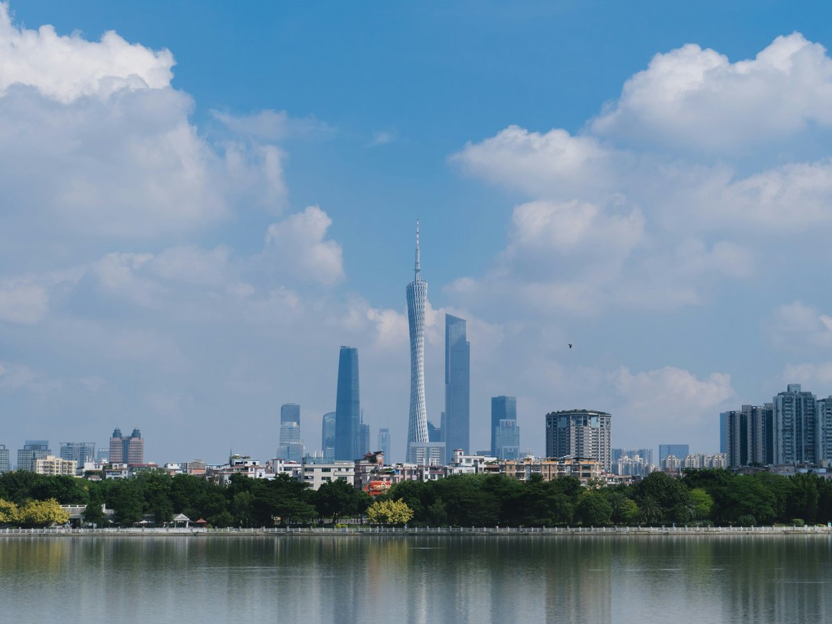 a large body of water with a city in the background