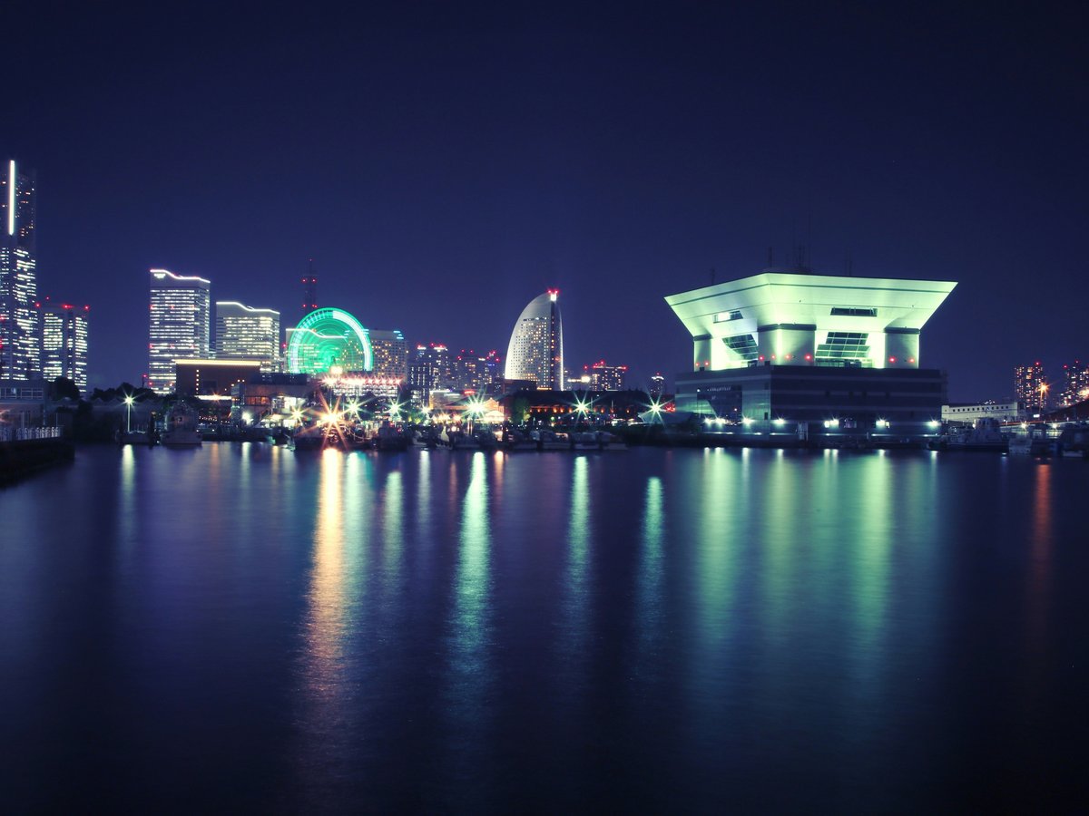 white concrete building near body of water during nighttime