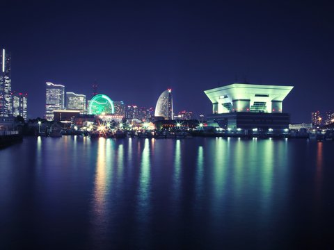 white concrete building near body of water during nighttime