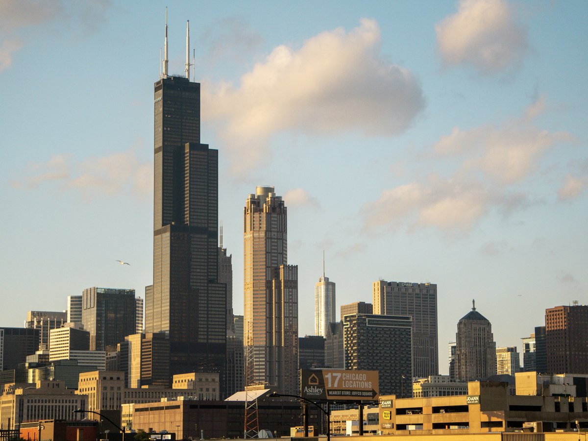 a city skyline with tall buildings in the foreground