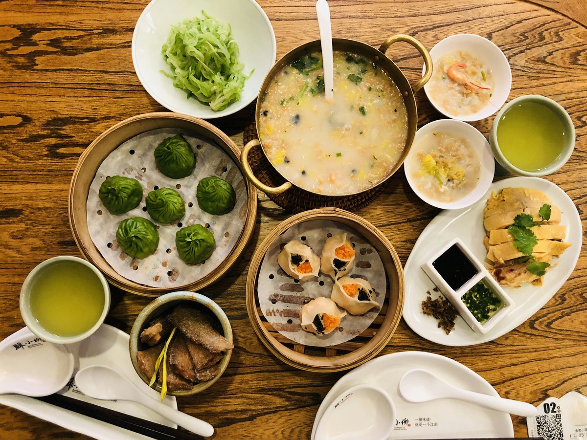 a wooden table topped with bowls of food