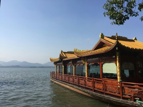 brown wooden house on body of water during daytime