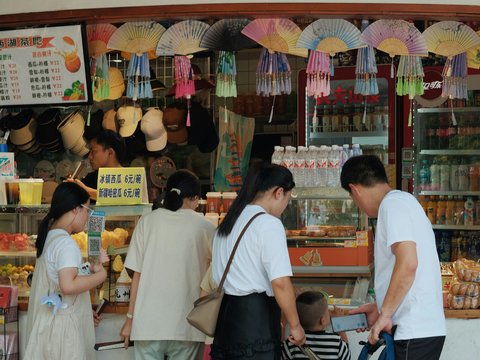 A group of people standing in front of a store