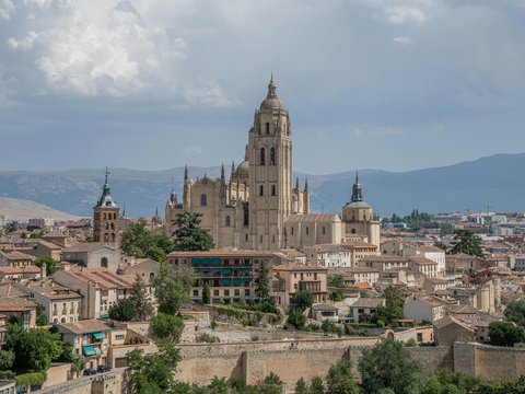 a large cathedral towering over a city filled with tall buildings