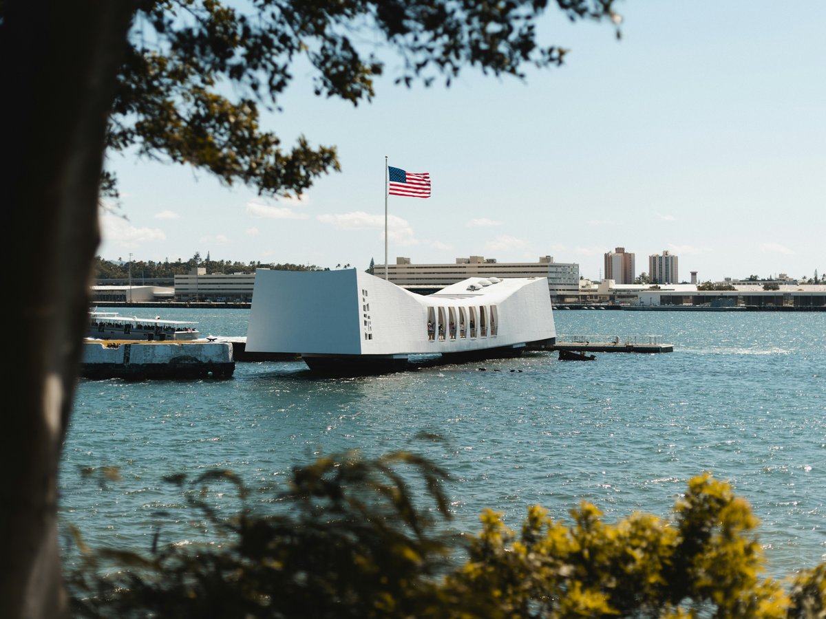 a large white building sitting on top of a body of water