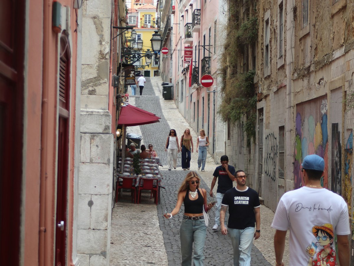 People walking down a narrow european street.