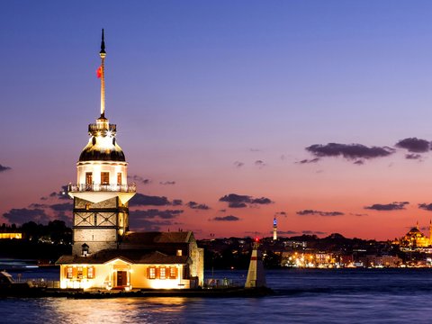 a large tower with a flag on top of it