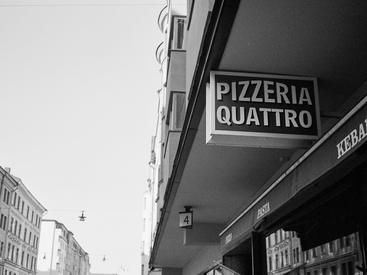 a black and white photo of a street corner