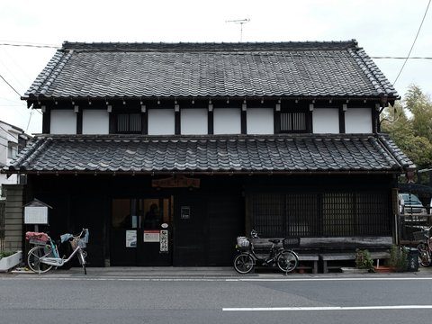a black and white building with a bicycle parked in front of it