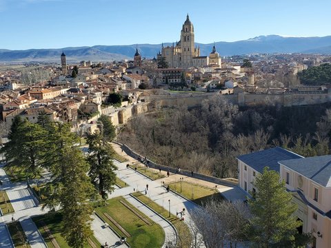 an aerial view of a city with mountains in the background