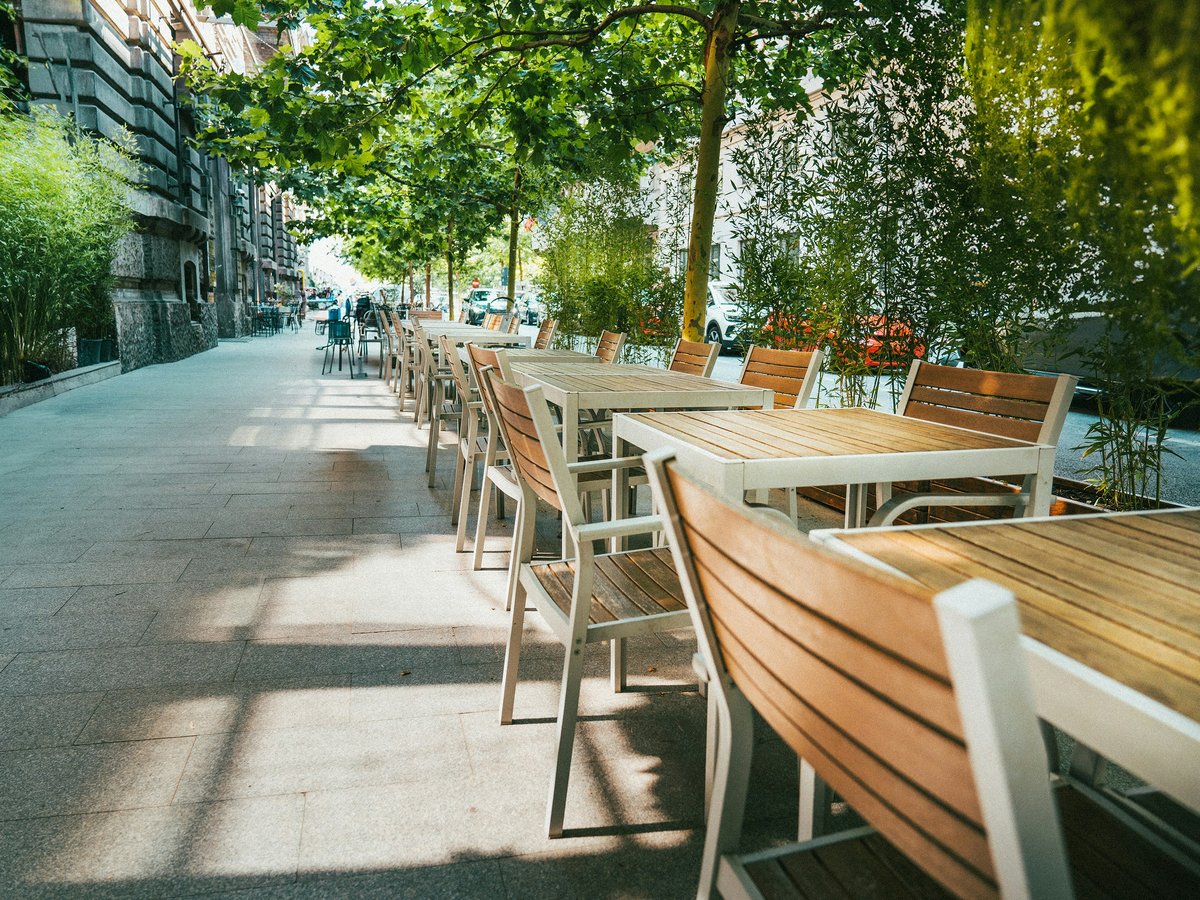 A row of tables sitting on the side of a road
