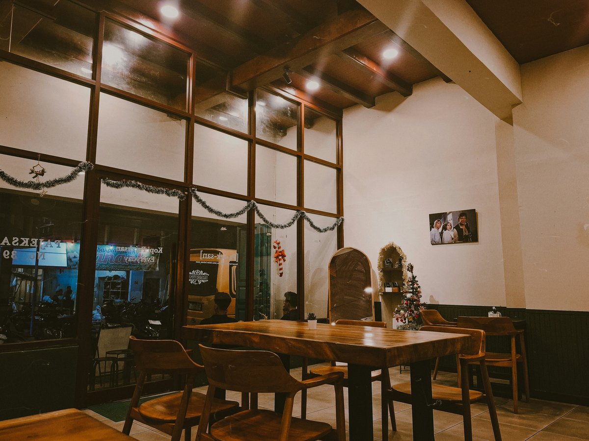 Cozy cafe interior with wooden tables and chairs