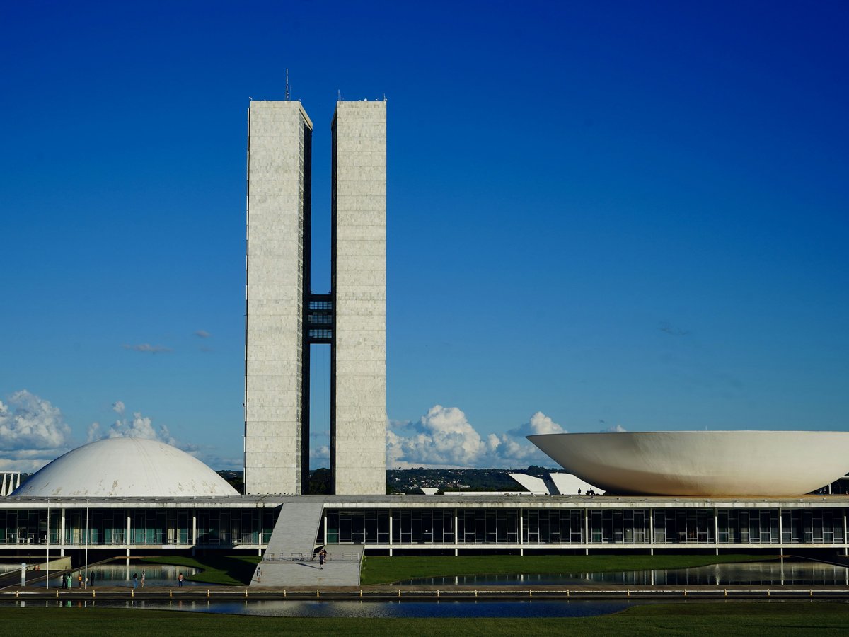 a large building with a tall tower next to a body of water