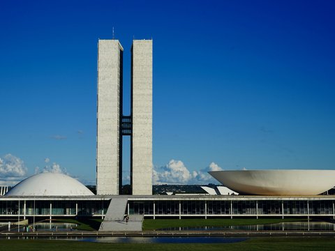 a large building with a tall tower next to a body of water