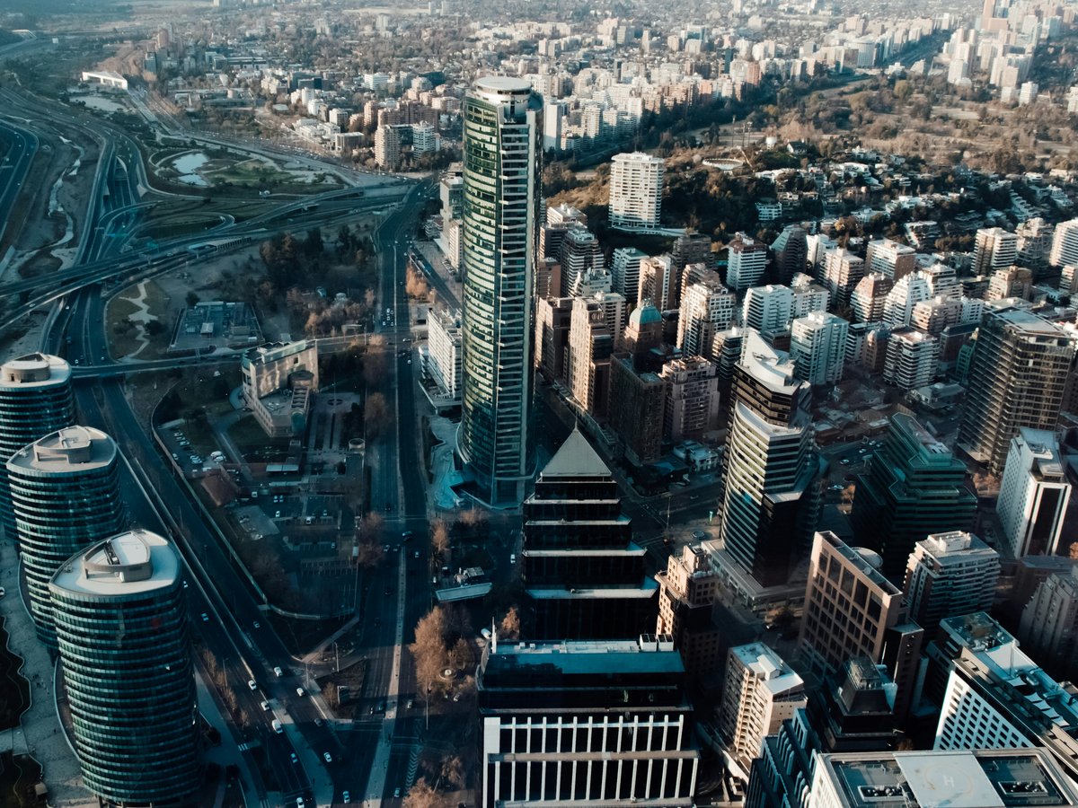 Aerial view of the Titanium La Portada skyscraper and surrounding city buildings in Santiago