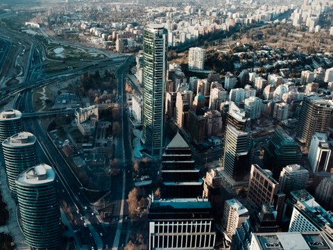 Aerial view of the Titanium La Portada skyscraper and surrounding city buildings in Santiago