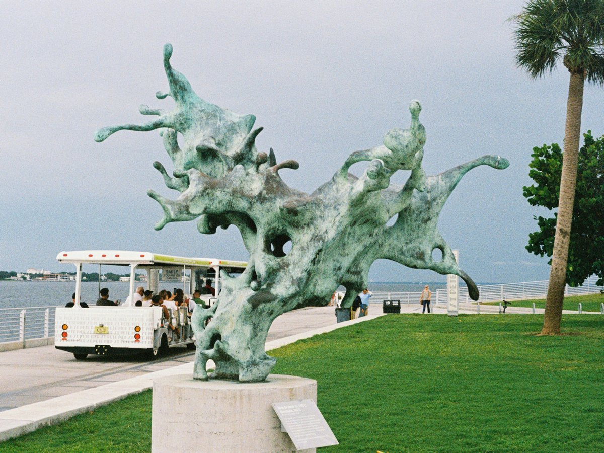A statue of a dragon on the side of the road
