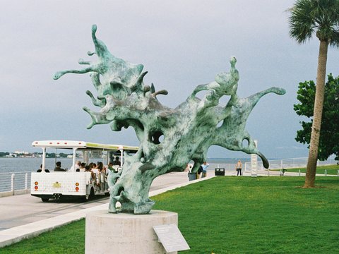 A statue of a dragon on the side of the road