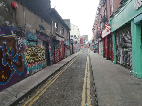 a city street with graffiti on the buildings