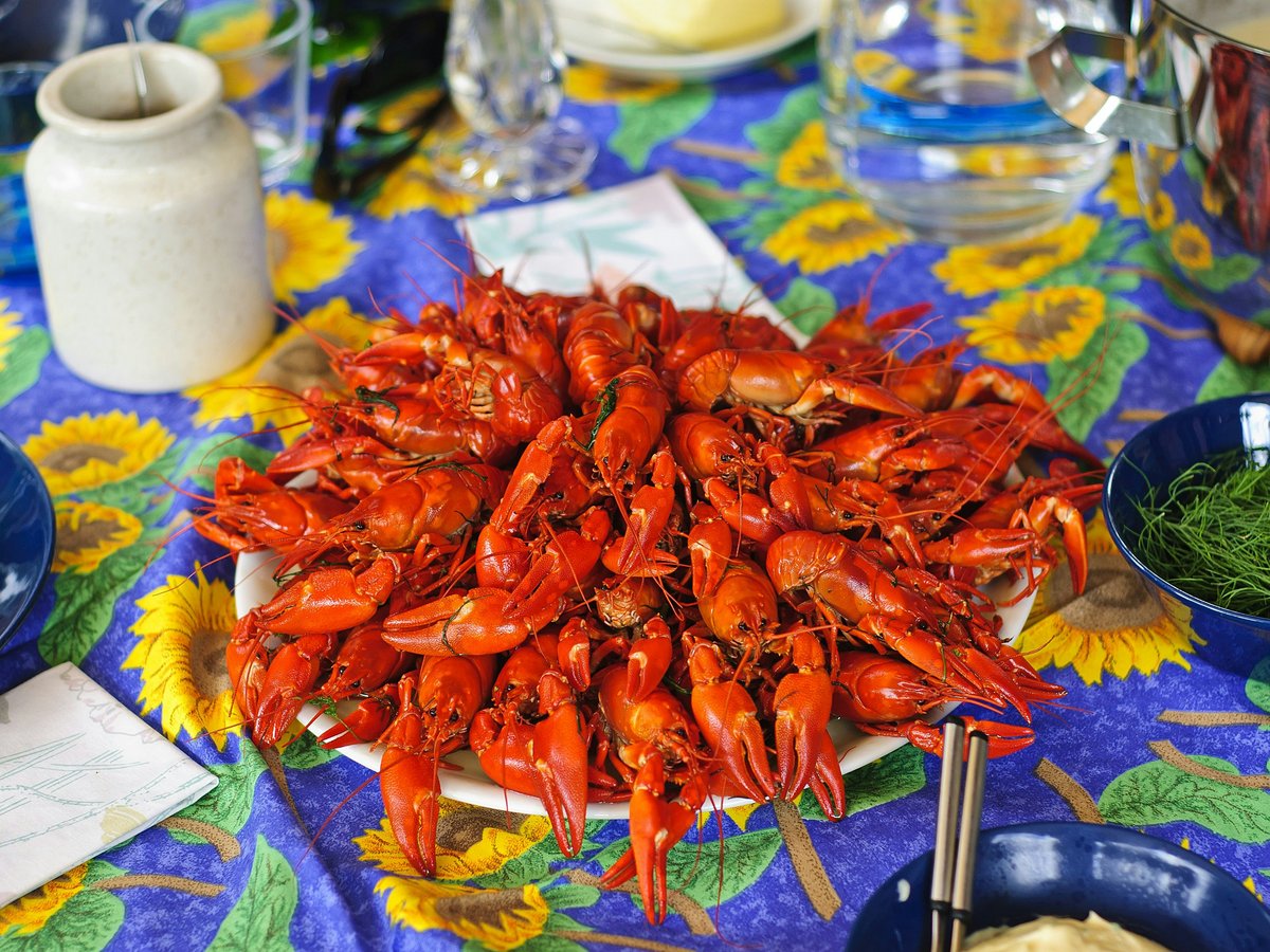 A plate of crayfish on a brightly colored table.