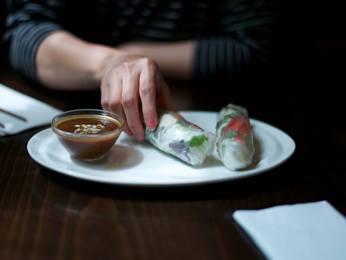 person holding white ceramic plate with food