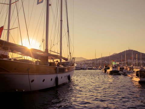A group of boats floating on top of a body of water