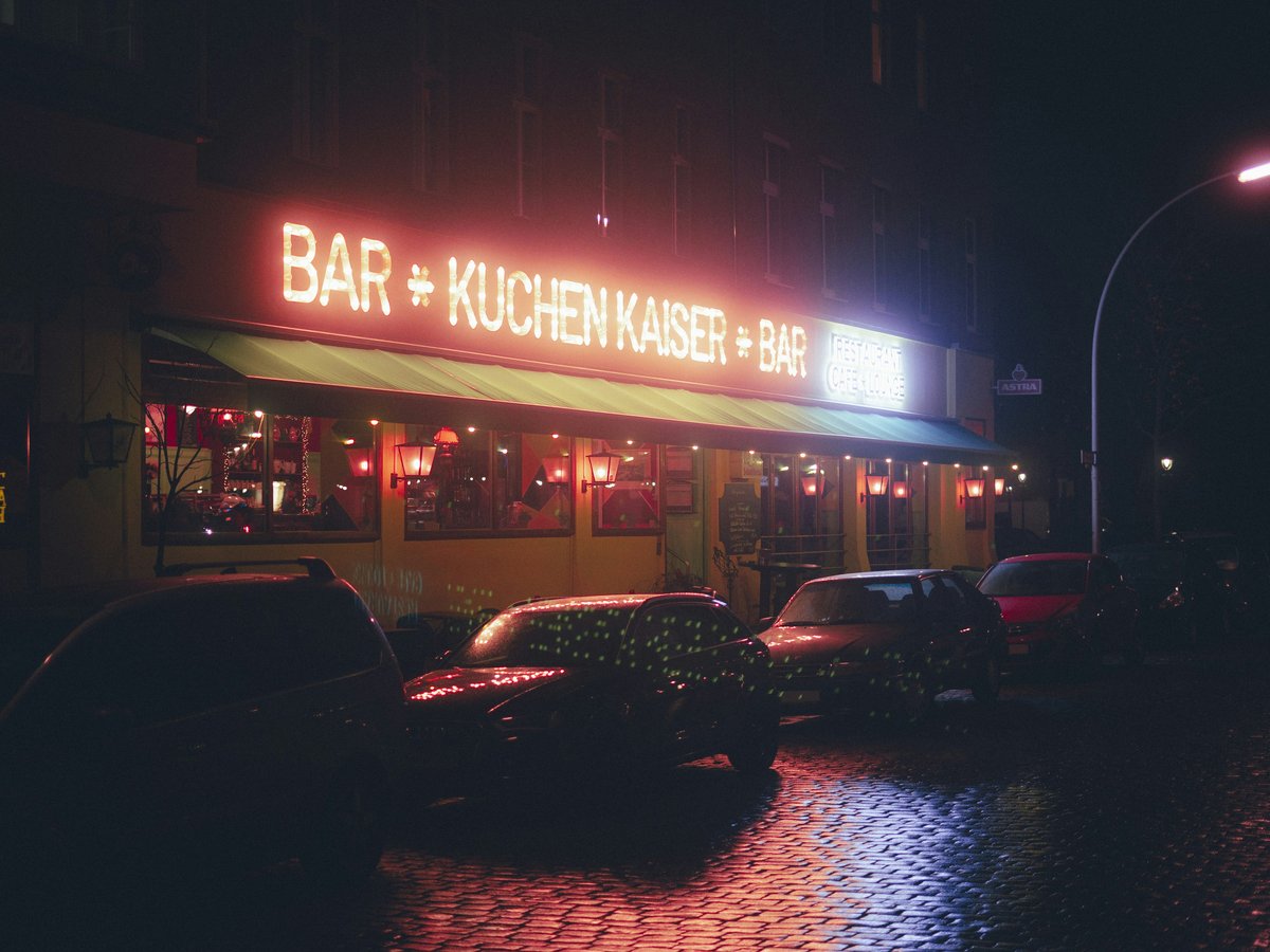 a restaurant with a neon sign lit up at night