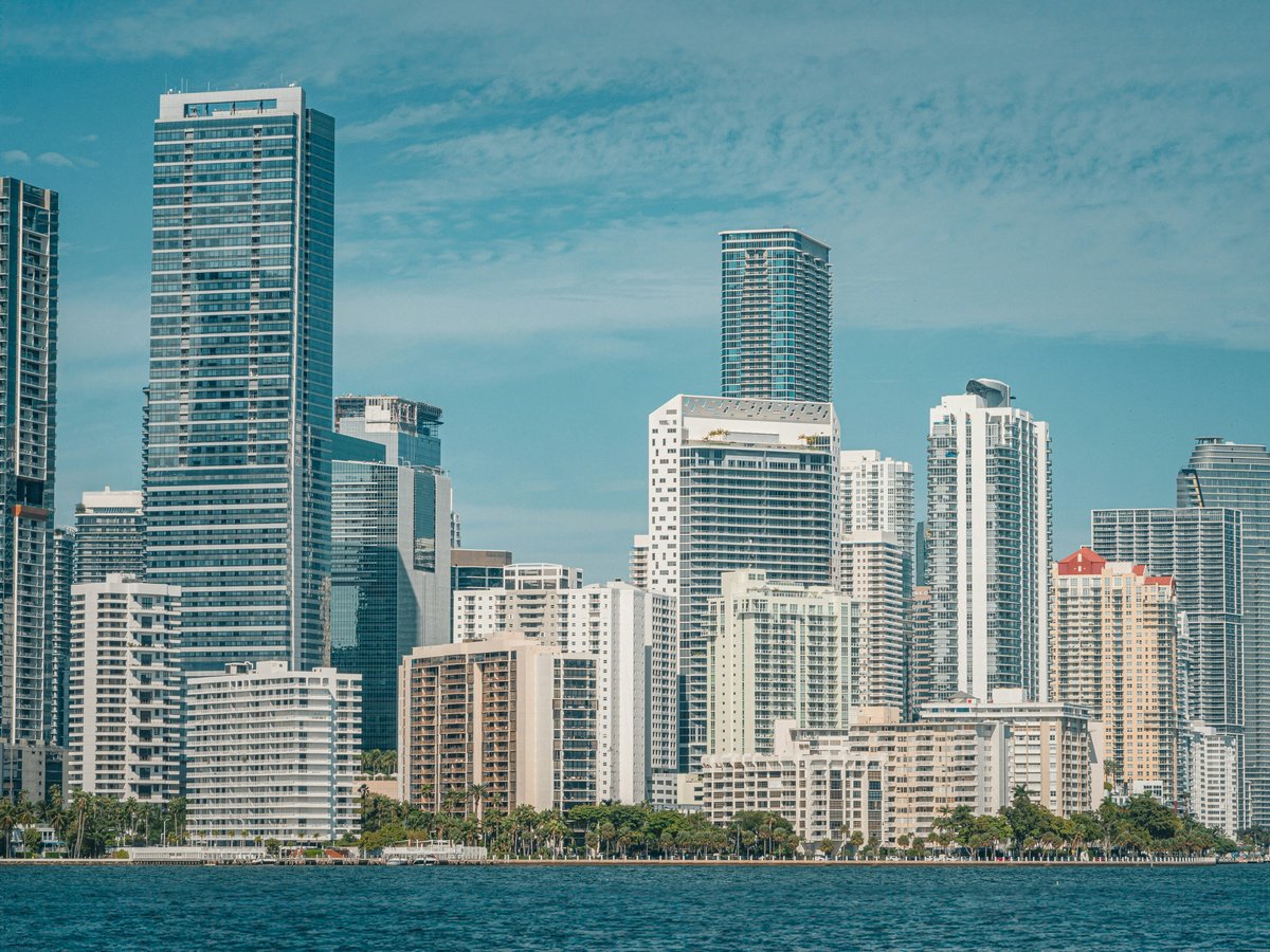 a large body of water with a city in the background