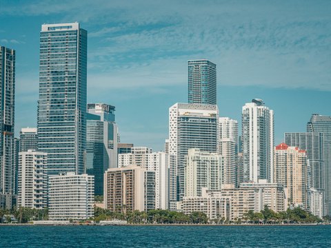 a large body of water with a city in the background