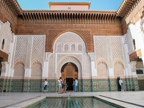 A group of people standing around a pool in a building