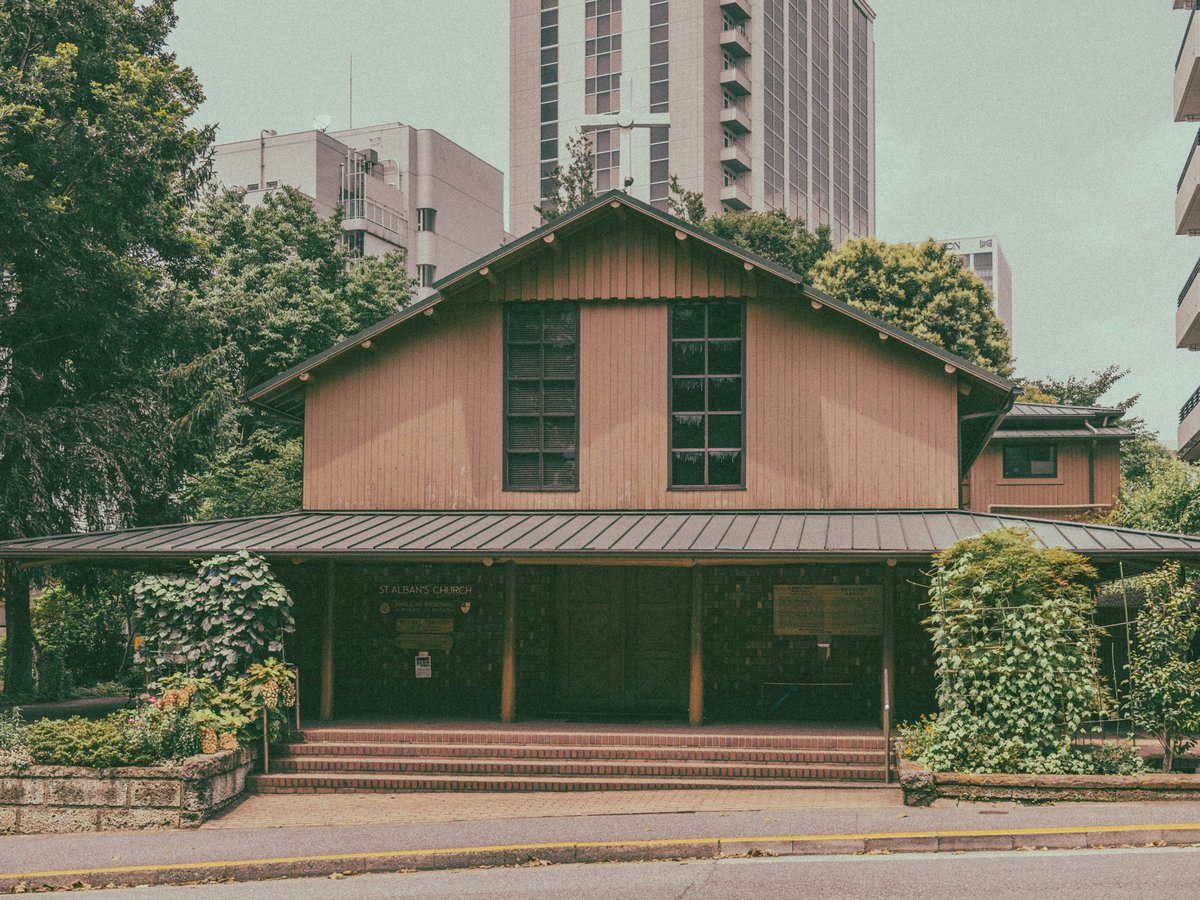 brown wooden house near green trees during daytime