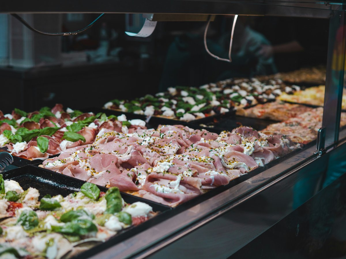 A display case filled with lots of different types of food