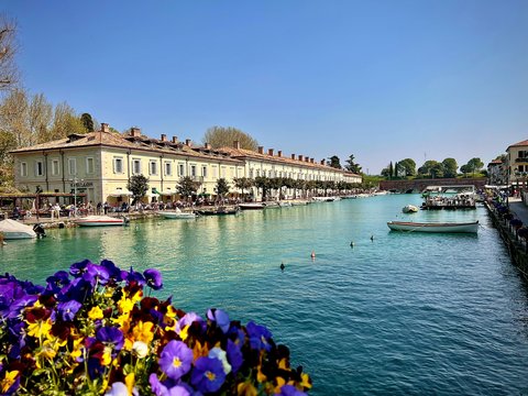 A beautiful waterfront town with boats and flowers