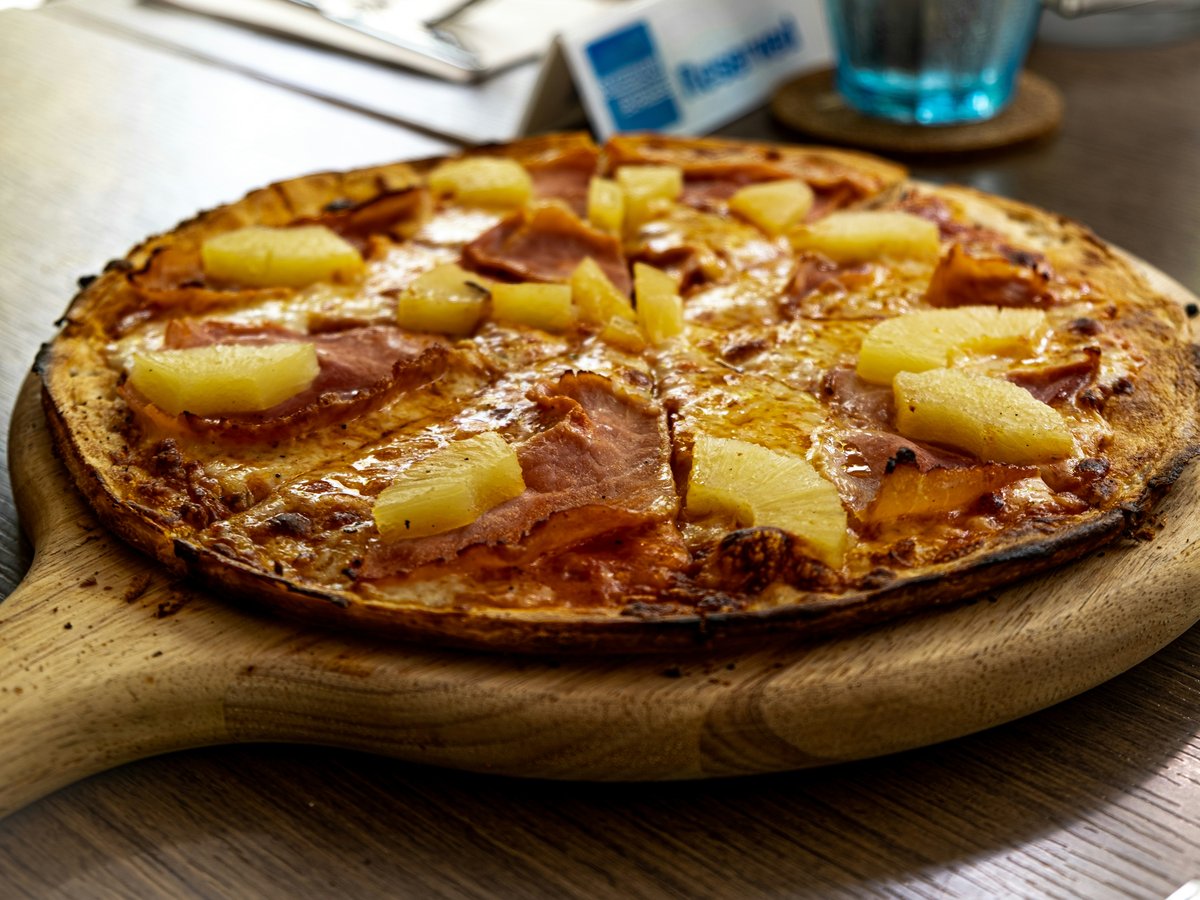 pizza on brown wooden round tray