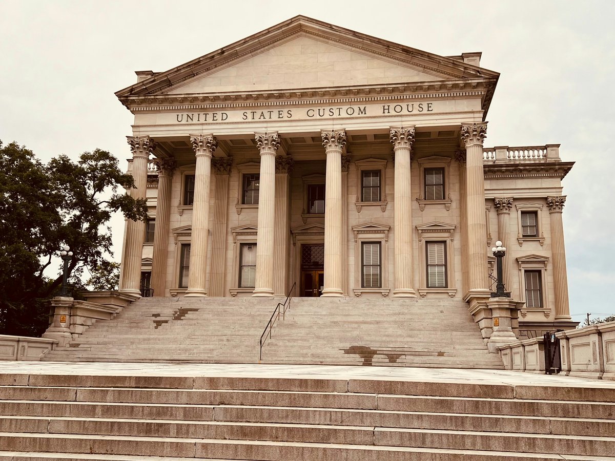 a large building with columns and steps leading up to it