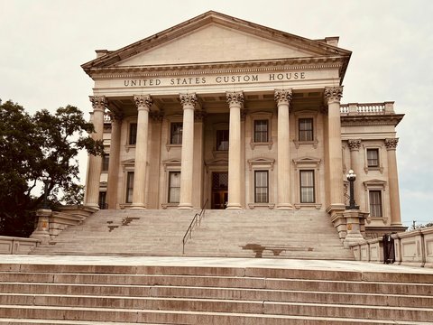a large building with columns and steps leading up to it