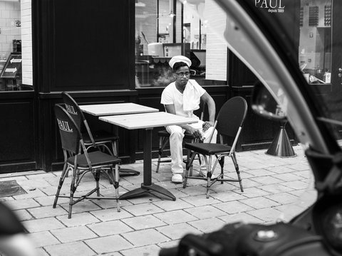 man in white dress shirt sitting on chair in grayscale photography