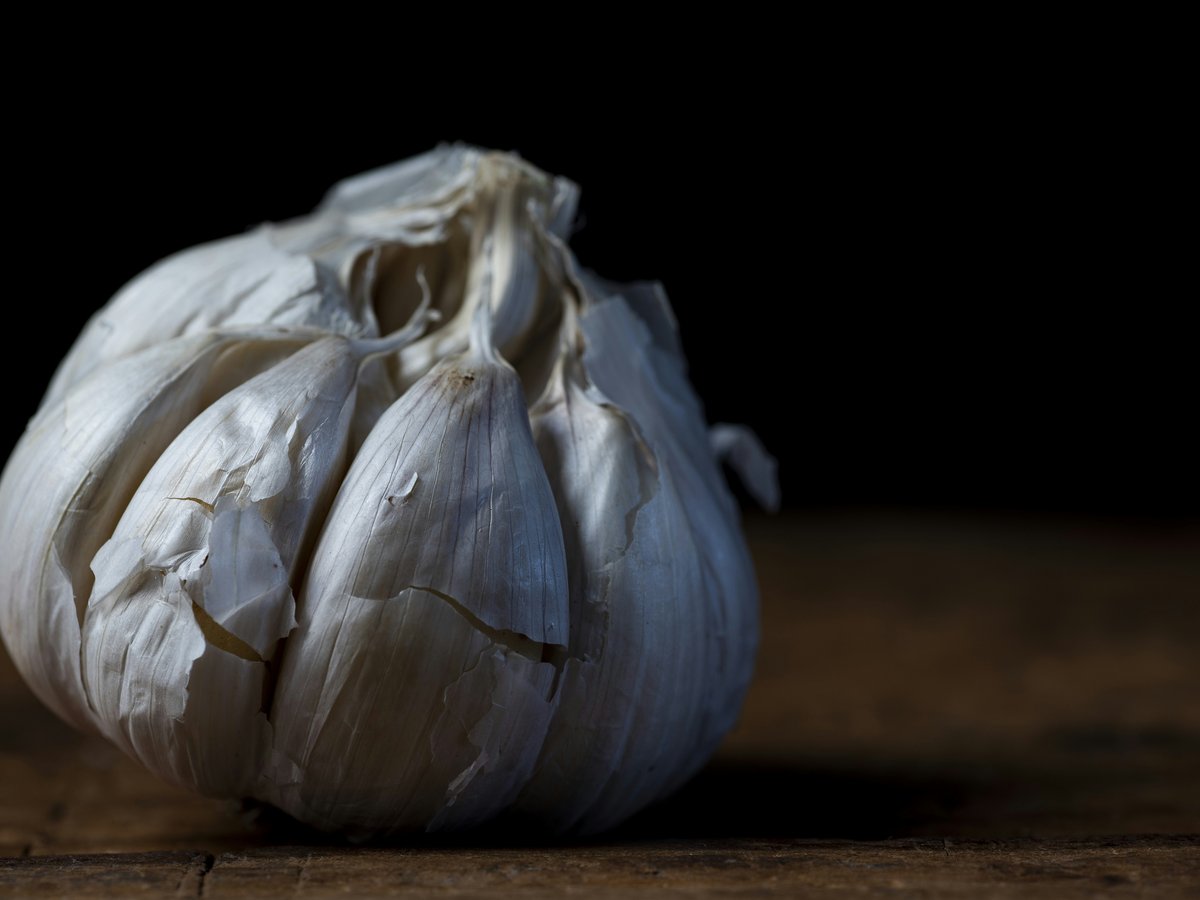 a white garlic on a wooden surface