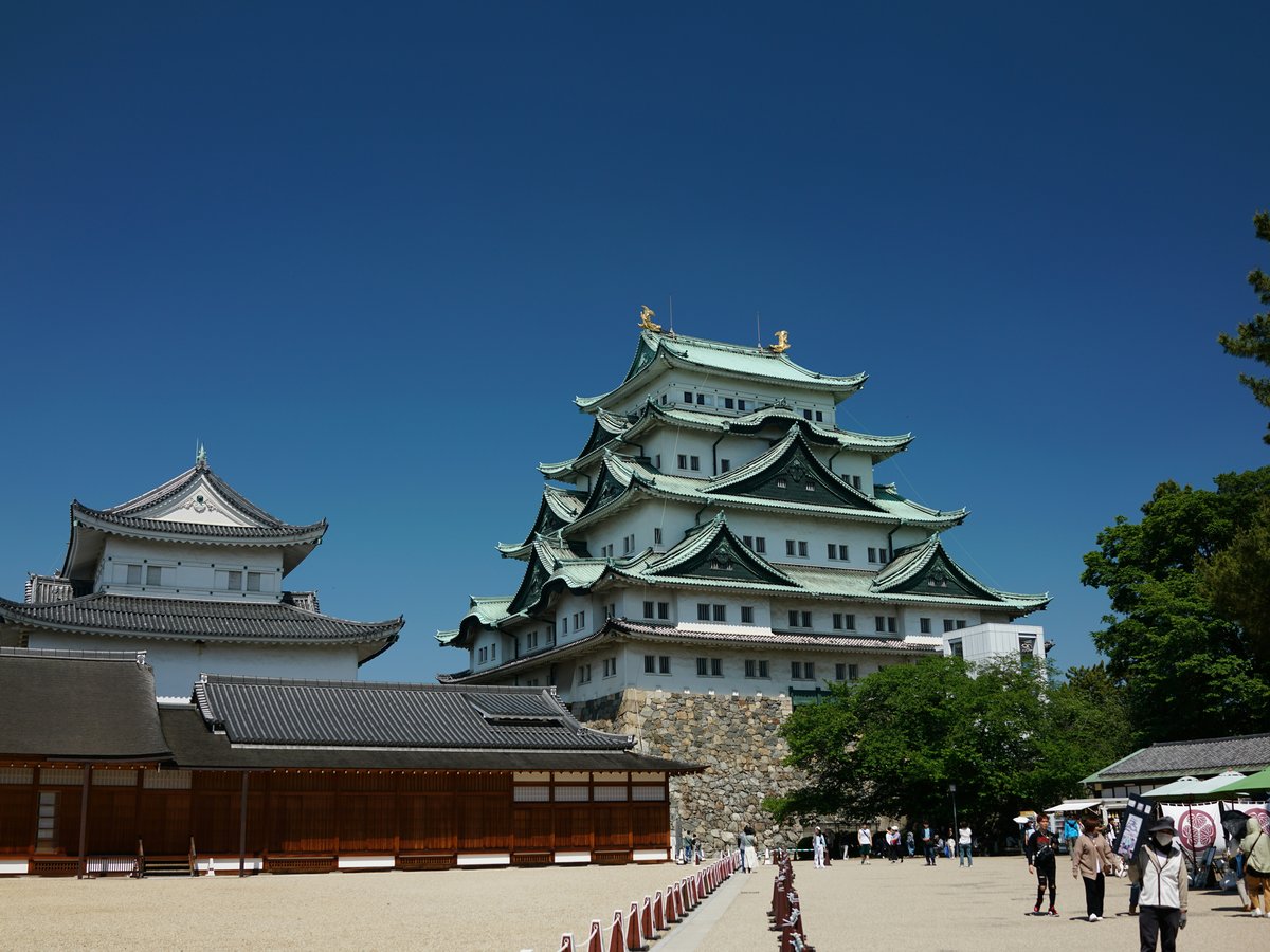 Nagoya castle stands tall against a blue sky