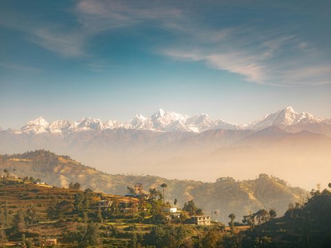 green trees and mountains under blue sky during daytime