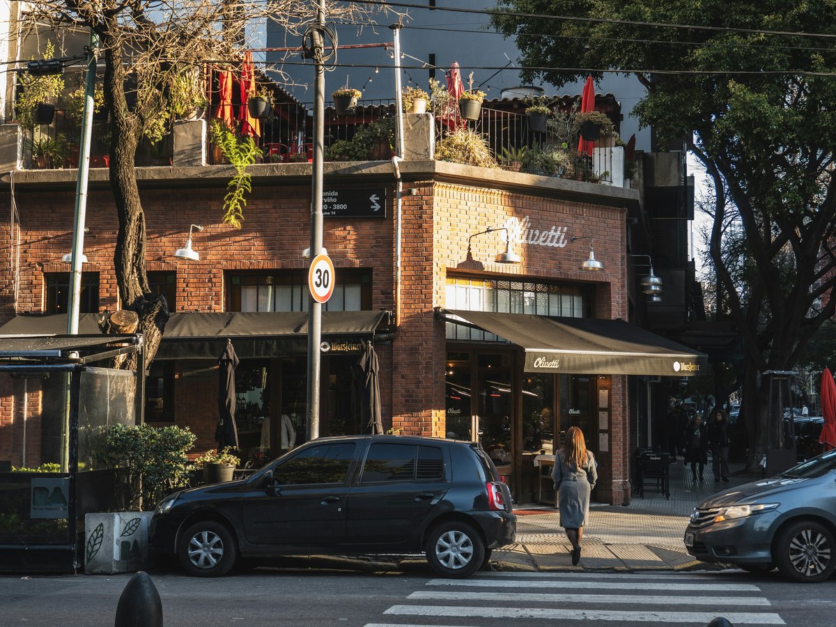 Brick building with awning and cars on street