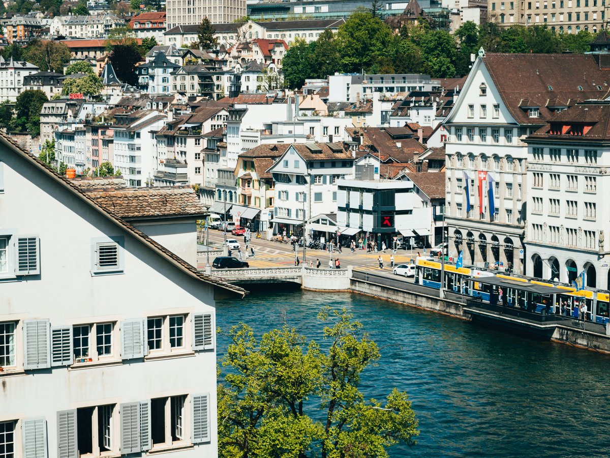 a river running through a city next to tall buildings
