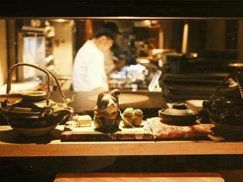 Chef working in a restaurant kitchen behind display