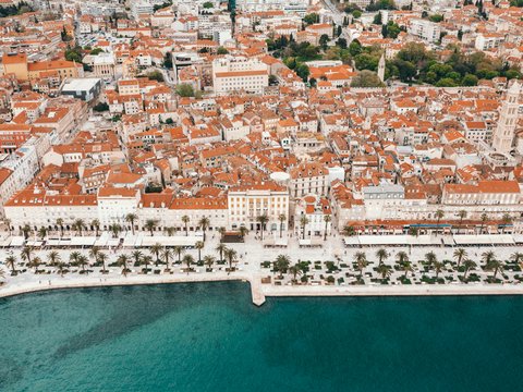 an aerial view of a city next to a body of water