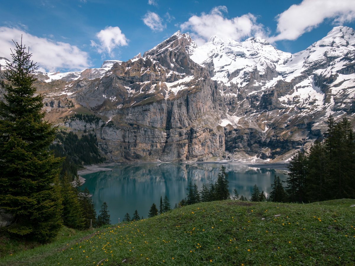 a view of a mountain range with a lake in the foreground
