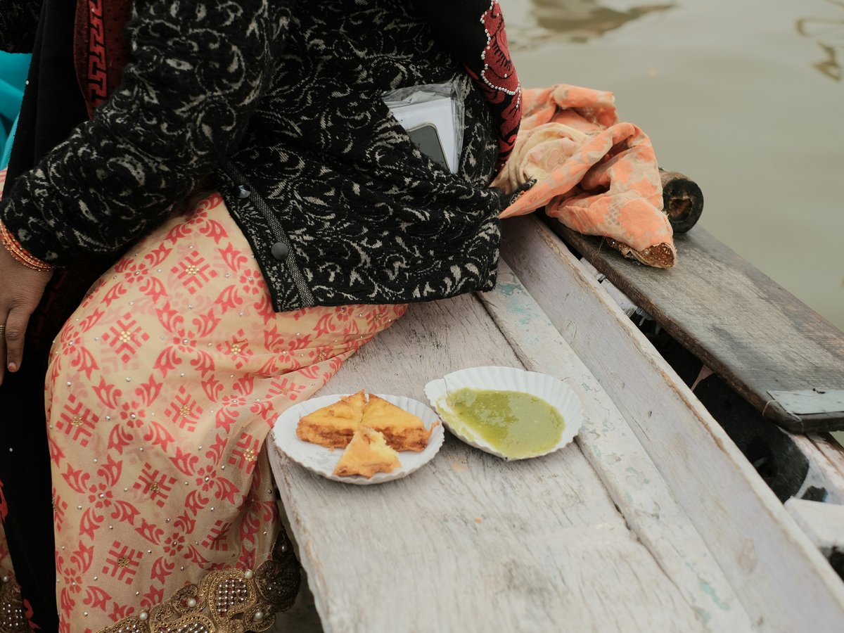 a woman sitting on a boat with a plate of food