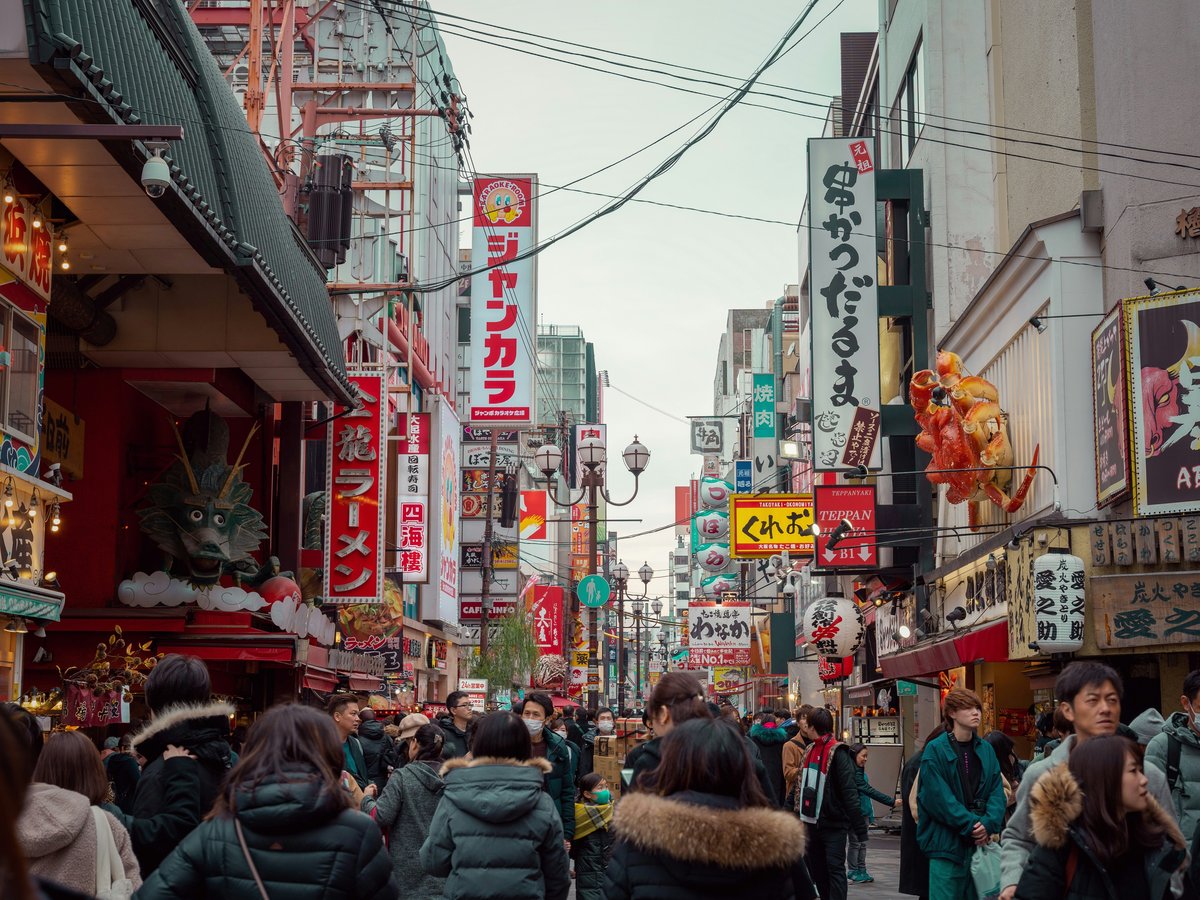 a crowded city street filled with lots of people