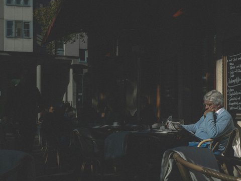 man in white dress shirt sitting on chair