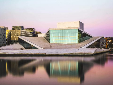 brown and white concrete building near body of water during daytime