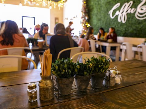 a wooden table topped with pots filled with plants